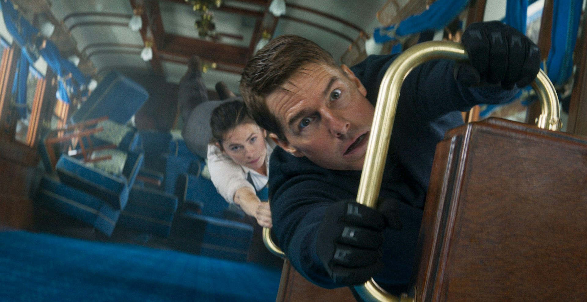Man and woman hang in an train carriage.