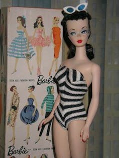 Brunette Barbie in white and black swimsuit.