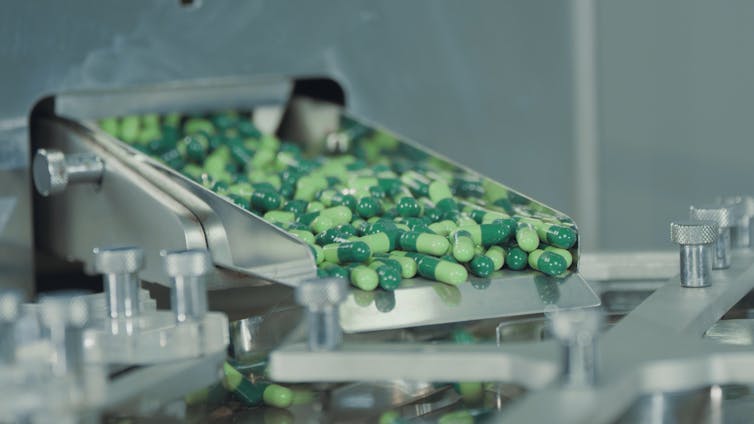 Green capsules coming off a manufacturing line