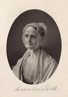 A formal, black-and-white photo of an older woman wearing a gauzy bonnet and shawl.