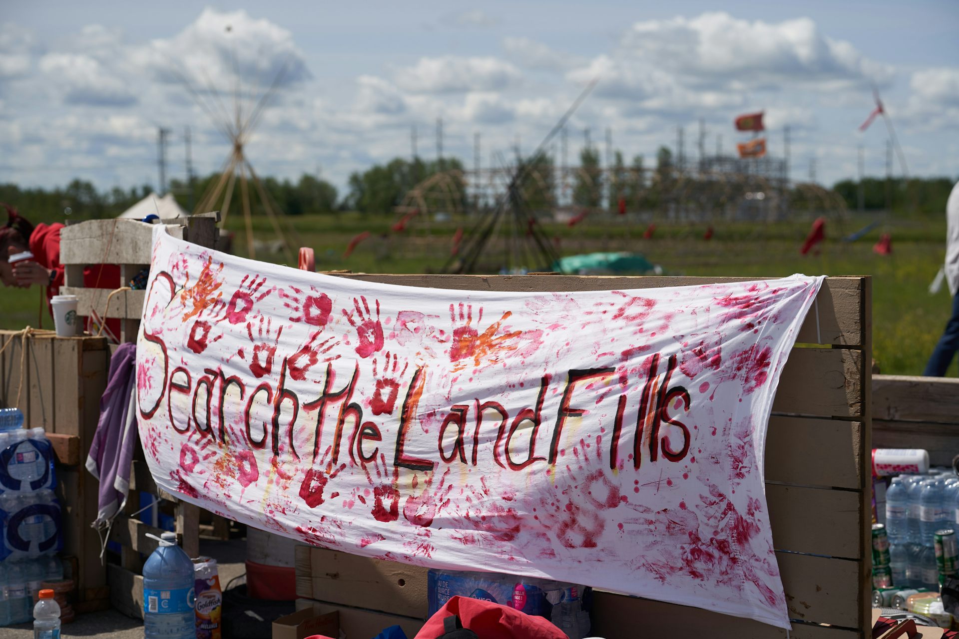 A sign with red hand prints and the words 
