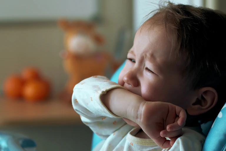 baby crying while sitting in high chair