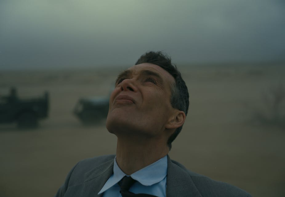 Cillian Murphy as J. Robert Oppenheimer looking up to the sky, squinting.