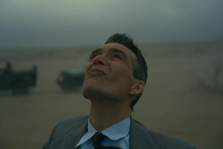 Cillian Murphy as J. Robert Oppenheimer looking up to the sky, squinting.