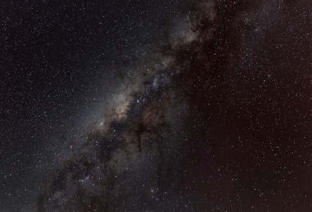 Why is space so dark even though the universe is filled with stars?