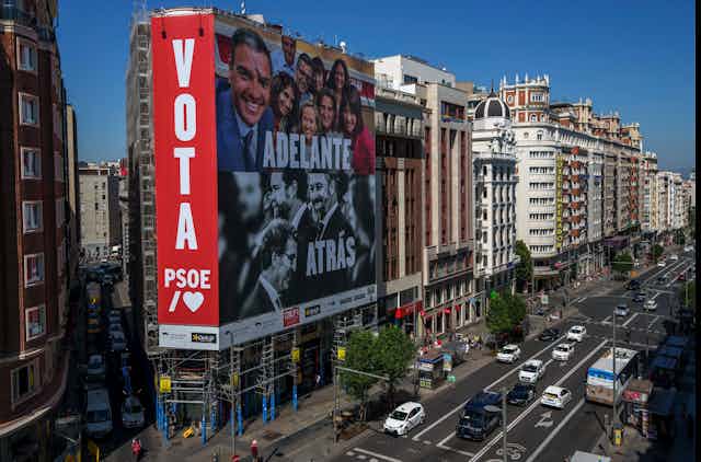 A banner urges citizens to vote in the early elections on a street in Spain