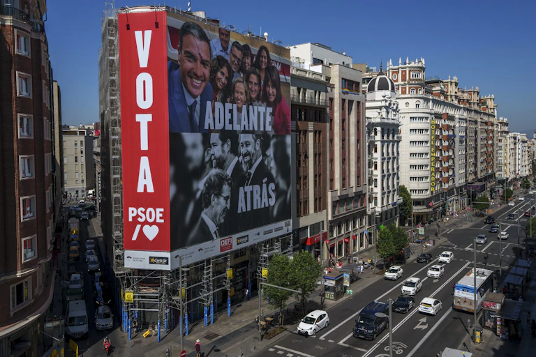 A banner urges citizens to vote in the early elections on a street in Spain