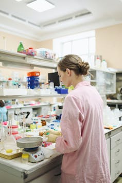 Scientist at a busy bench in a lab