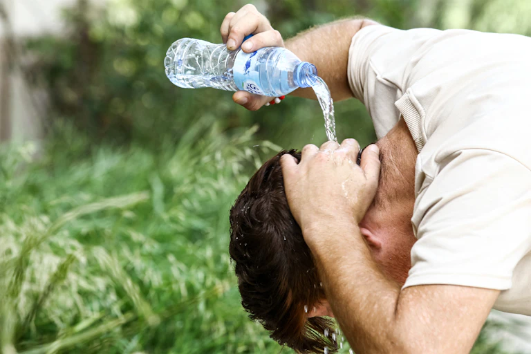 Man pours water on his head