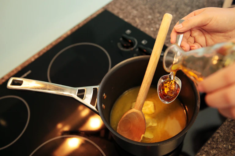 liquid being poured over pot on electric stove