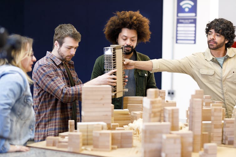 A group works on building design in an office.