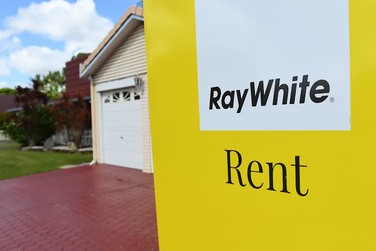 sign reads 'Ray White: Rent in front of house'