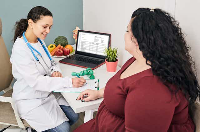 An overweight woman consulting with a doctor