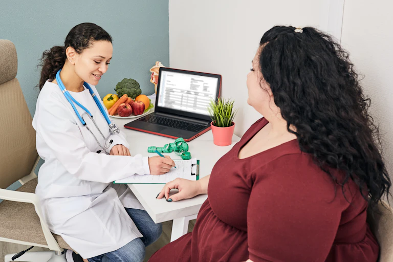 An overweight woman consulting with a doctor