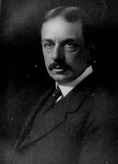 black and white photo of Osborn in a black suit.