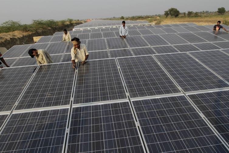 people in India work at solar farm