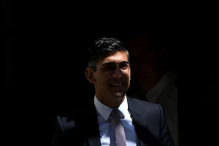 Rishi Sunak's face, in shadows