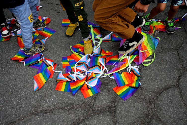 Kids stomp on pride flags.