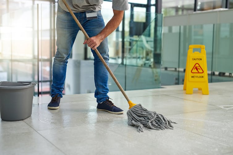 Man mopping floor