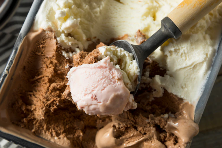 Close up scoop of neapolitan ice cream with pink visible on top