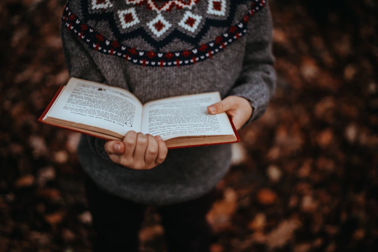hands holding an open book