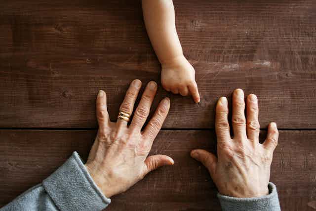 child and adult's hands