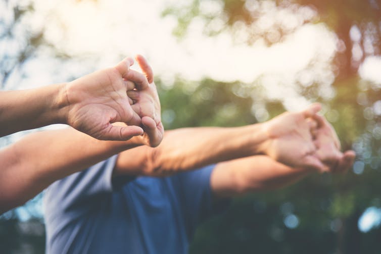 People stretch their arms