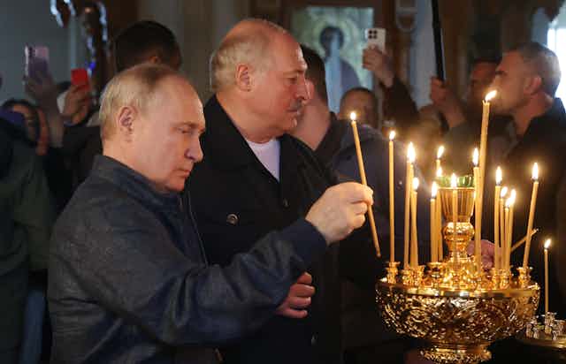 Russian president Vladimir Putin and Belarus president Alexander Lukashenko light candles at a Russian orthodox monastery in Russia, July 2023.