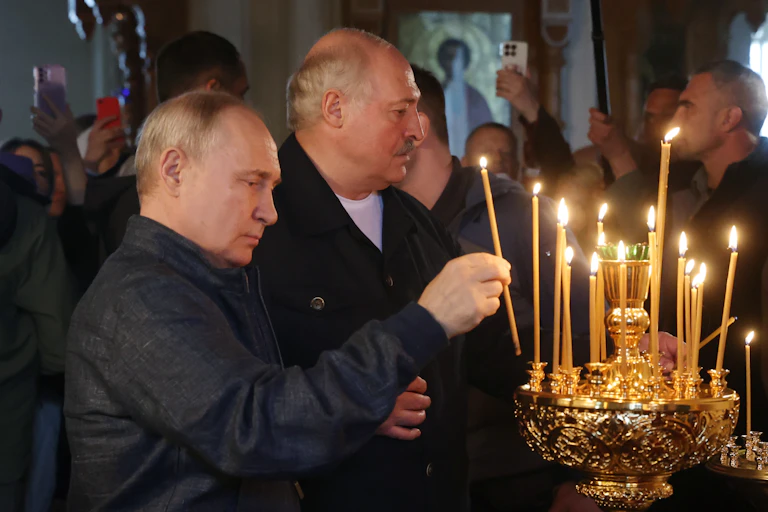 Russian president Vladimir Putin and Belarus president Alexander Lukashenko light candles at a Russian orthodox monastery in Russia, July 2023.