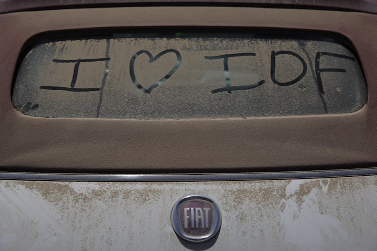 'I love the Israeli Defence Force' (IDF) is marked in the dust of the rear window of a car