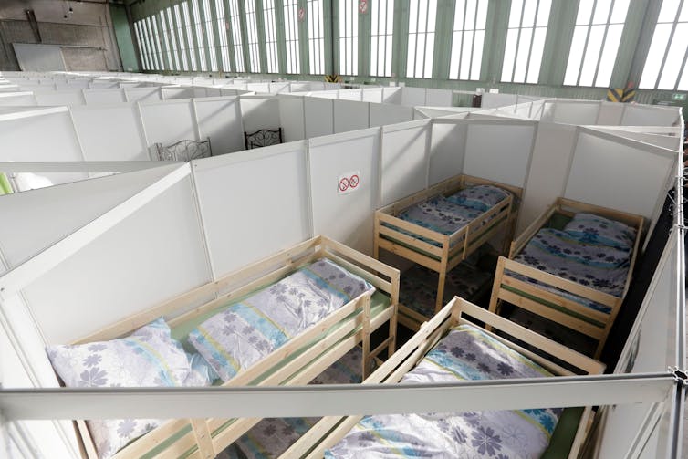 An overhead view of temporary shelters in a hangar.