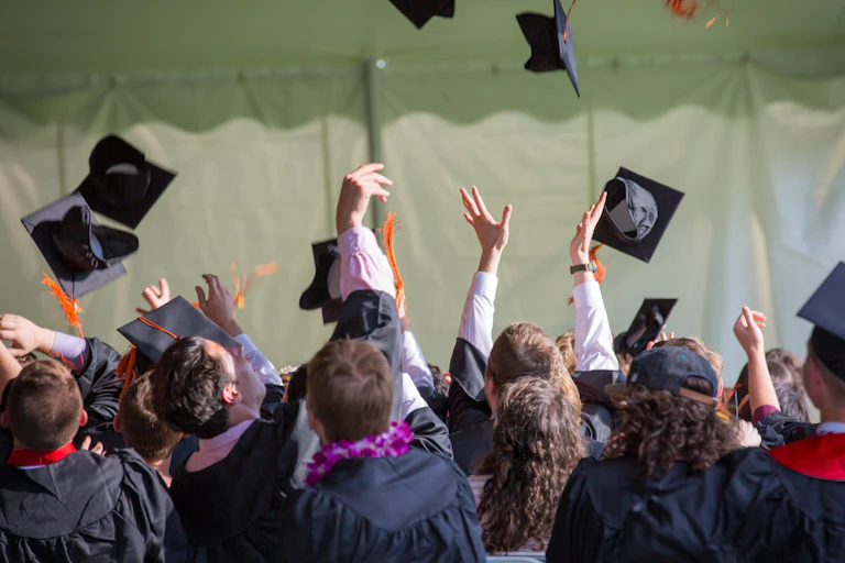 People seen throwing graduation hats in the air.