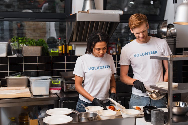 Two volunteers in a kitchen