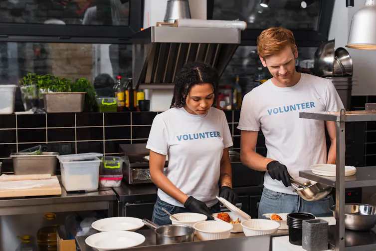 Two volunteers in a kitchen