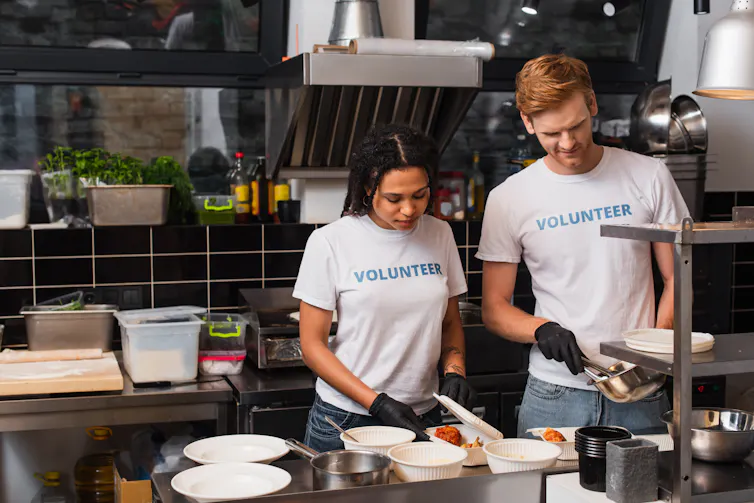 Two volunteers in a kitchen