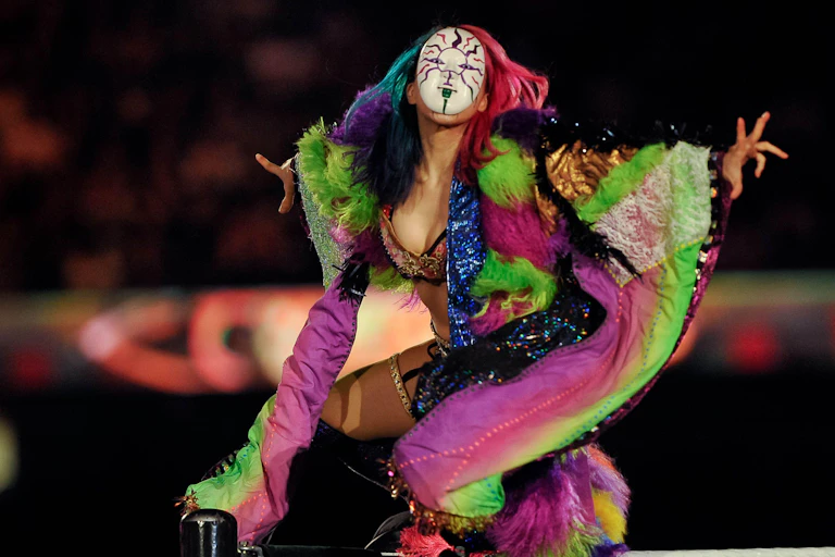 Asuka in a mask and colourful robe.