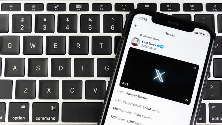 Smartphone showing Elon Musk's X profile will the new logo for the platform.