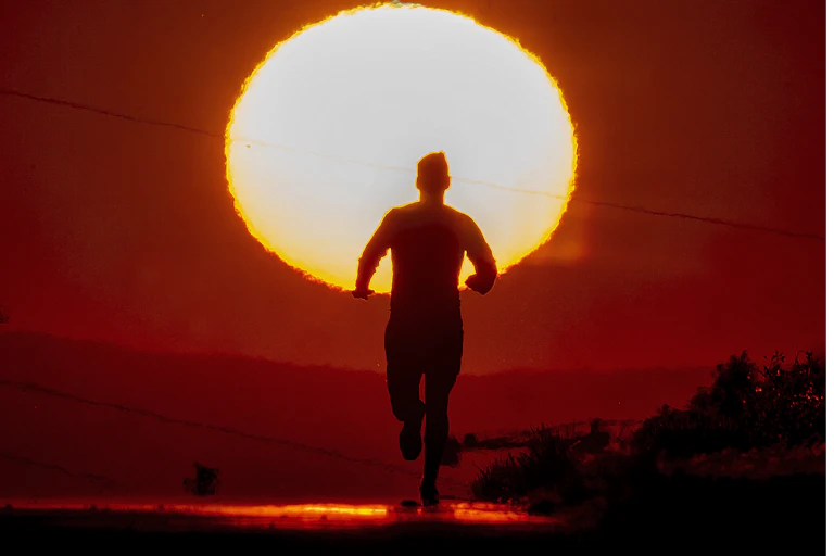 A person runs under a hot sun