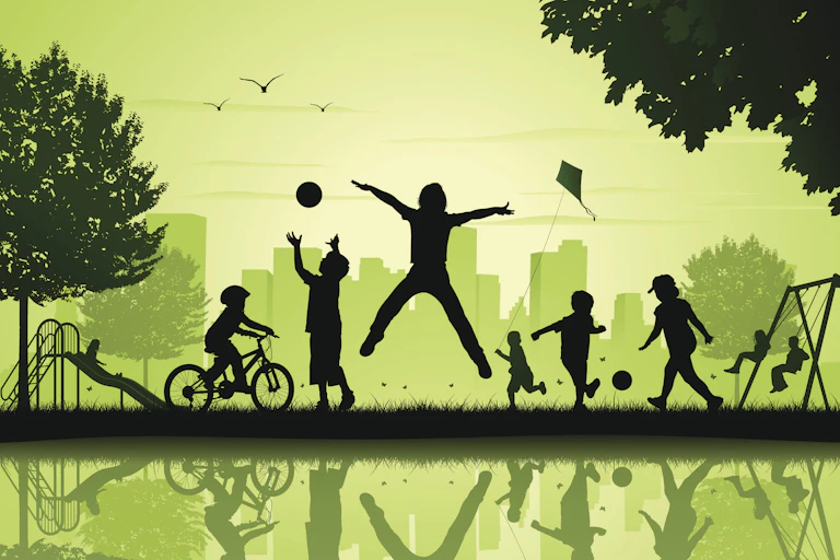 Silhouette of children playing in a city park, with a city skyline behind them and their reflections off of water in front of them.