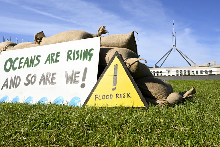 A replica seawall build from sandbags by Traditional Owners from the Torres Strait is seen during a rally calling for stronger action on climate change outside Parliament House in Canberra, Monday, November 7, 2022.