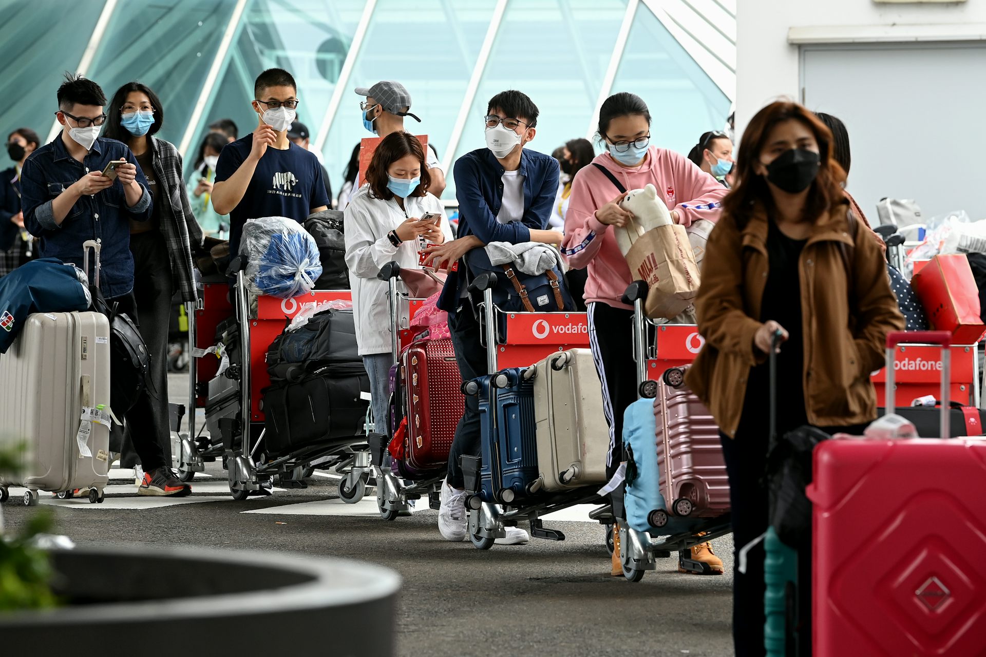 International students queue with bags as they arrive at Sydney airport in December 2021.