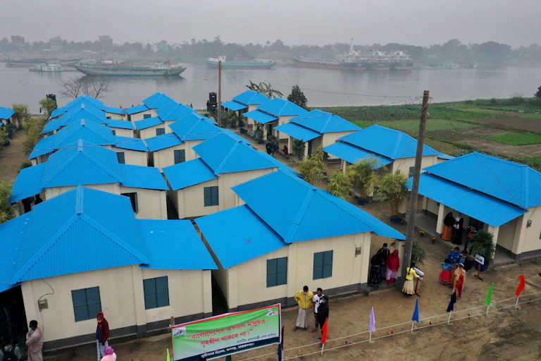A bird's eye view of a housing development with blue roofs.