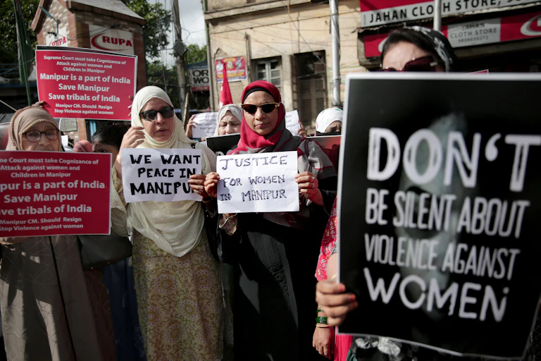 A group of Muslim women hold up placards in protest at sexual violence.