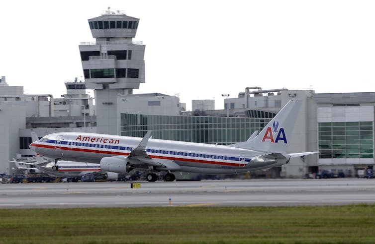 An airplane emblazoned with the old American Airlines branding at an airport.