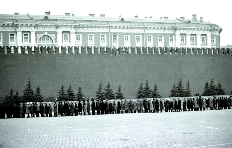 An archival photograph of people queuing.