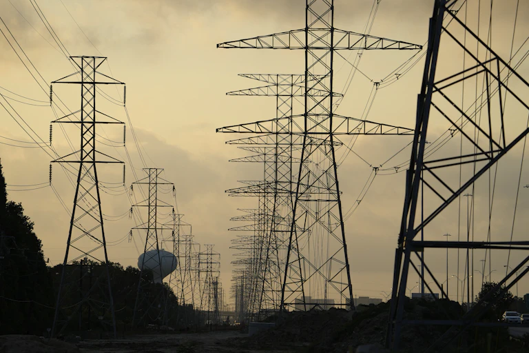 Power lines fading into the distance of a hazy evening.