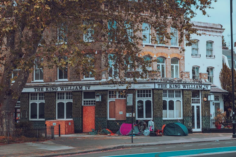 Tents are pitched outside a pub in London.