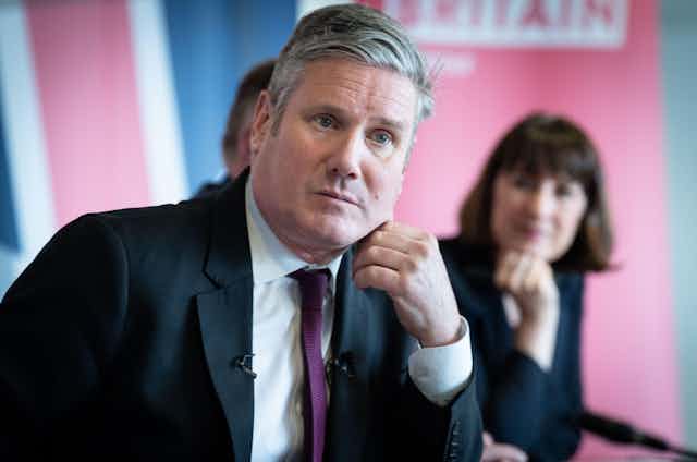 Keir Starmer in the foreground and an out-of-focus Rachel Reeves in the background.