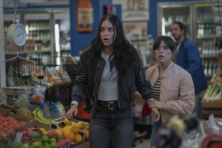 Two women looking terrified in a supermarket.