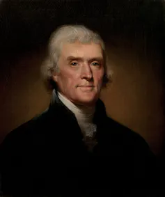 A dark portrait of a man in 18th century jacket and white blouse, with fine features.